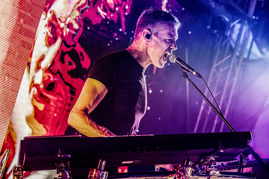 Keyboarder Tony Clare von Remode singt am Mikrofon hinter seinen Keyboards, live in Wittenberg